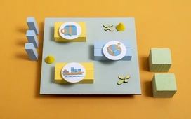 Colorful blocks with AI lifecycle icons representing data analysis, model training, and deployment steps used when developing AI models in Google Colab.