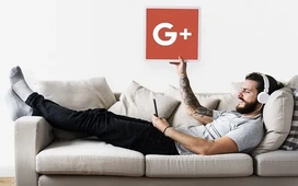 Man relaxing on a couch using a tablet with headphones, symbolizing how tools like Google Colab enable effortless cloud-based coding for beginners and pros.