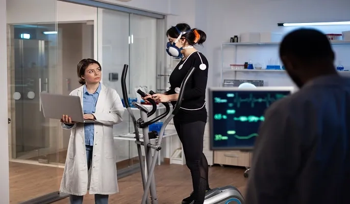 Medical staff monitoring a patient wearing sensors during a clinical test, illustrating how AI enhances healthcare training and medical technology skills.
