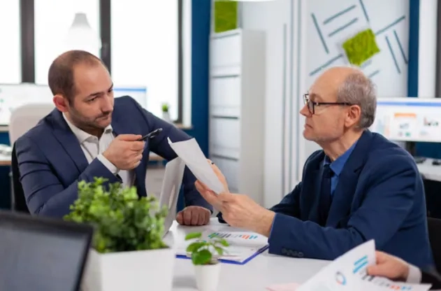 Professionals reviewing risk reports in an office – earn your Associate in Risk Management Certification online with Learning College