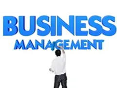 Business professional standing before large “Business Management” text, symbolising leadership, growth, and management studies.
