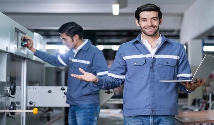 Facility technicians using machinery and digital tools, illustrating practical skills essential for becoming a certified facilities manager online.