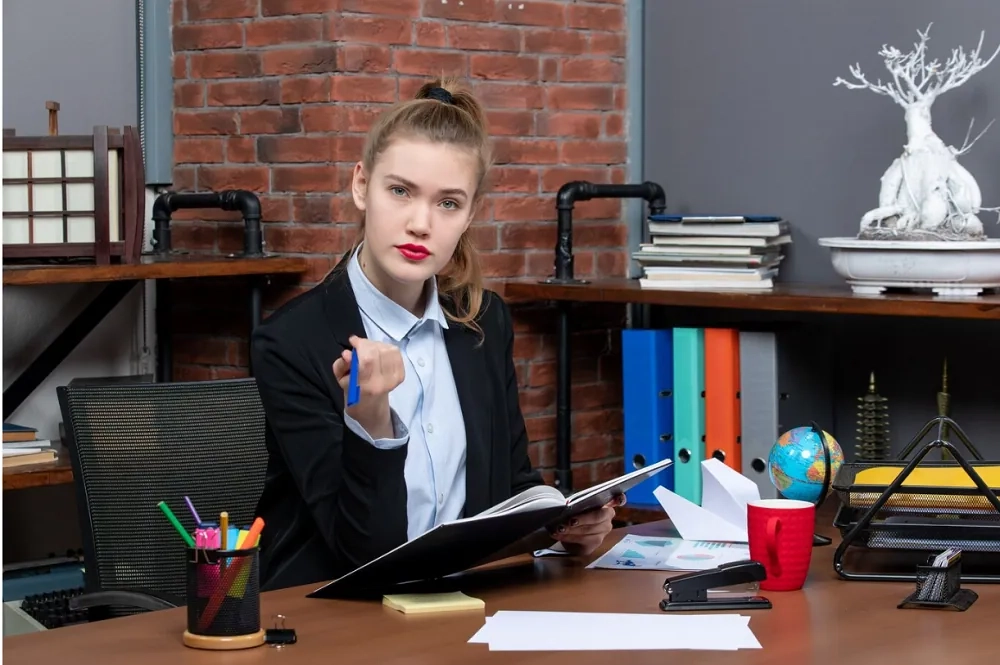Professional woman reviewing financial documents in an office setting, representing the role and responsibilities of a Certified Public Accountant.