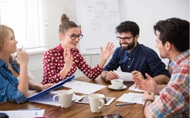 Team having an animated discussion in a meeting – learn how to improve communication skills for work and study.