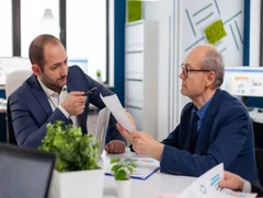 Professionals reviewing risk reports in an office – earn your Associate in Risk Management Certification online with Learning College