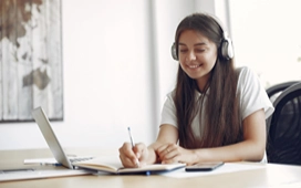 Student studying on a laptop at home, exploring free online courses and flexible online learning options in the UK