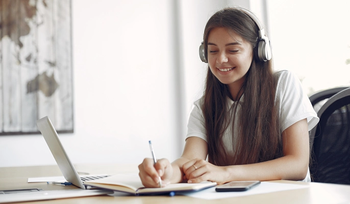 Student studying on a laptop at home, exploring free online courses and flexible online learning options in the UK