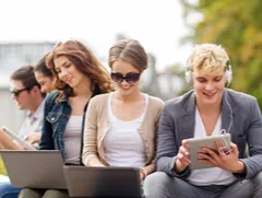 Students using laptops and a tablet outdoors, representing free short online courses with certificates and flexible study.