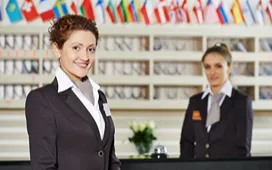 Two hospitality professionals at a hotel reception desk, representing ways to boost skills and career prospects in the hospitality industry.