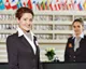 Two hospitality professionals at a hotel reception desk, representing ways to boost skills and career prospects in the hospitality industry.