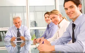 Group of business professionals in a meeting, illustrating teamwork and highlighting differences between leadership and management roles.