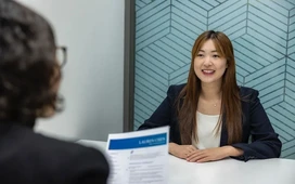Job candidate speaking with recruiter in an interview, illustrating local employment opportunities and career guidance.