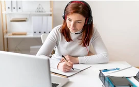 Student taking notes during online lesson at home – discover top free OHSC courses and certificates.