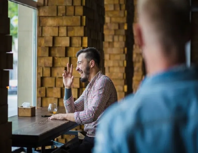 Man engaged in a focused conversation, showing reflective listening and active communication skills for online learners.