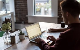 Professional working on a laptop from home, representing remote employment opportunities and flexible career growth.