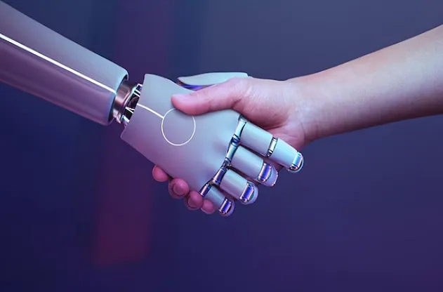 Human and robot shaking hands – beginner’s guide explaining what machine learning is and how it works