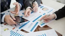 Professionals reviewing business information, illustrating adaptability skills, flexibility and workplace problem-solving abilities