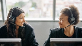 Customer support professionals wearing headsets during customer service training for employees in a support centre
