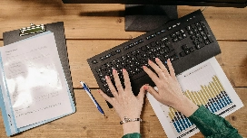 Advanced professional entering data on a laptop, learning data entry classes online at OHSC – work from home opportunities