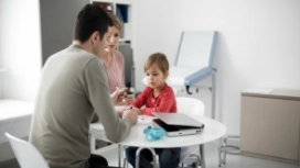 Adult supporting a child during a conversation, illustrating emotional resilience, coping skills and personal strength
