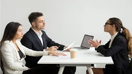 HR professionals interviewing a candidate in a formal meeting, illustrating advanced human resource management concepts at Level 5.