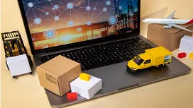 Laptop displaying global supply chain network with miniature transport models, symbolizing advanced logistics and supply chain operations.