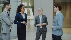 Business professionals discussing workplace communication strategies in a modern office – soft skills course online