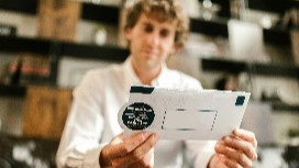 Man holding a branded envelope, symbolizing personalized marketing, customer engagement and AI-enhanced strategies in modern digital marketing.