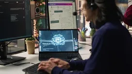 Person working on a laptop with AI graphics and code on screen, representing data preprocessing tasks essential for preparing datasets in artificial intelligence.
