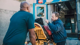 Emergency responders assisting a patient into an ambulance, symbolizing real-time decision support and AI-enhanced tools in incident management.