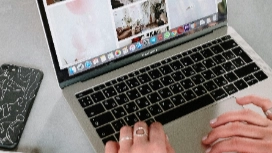 Hands using a laptop for online brand promotion and analytics – AI in fashion marketing short course by OHSC.