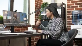 Two professionals reviewing project plans outdoors, symbolizing how AI supports communication, coordination, and collaboration in remote teams.