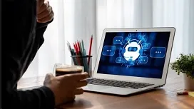 A person viewing a laptop displaying an AI chatbot interface, symbolizing how artificial intelligence supports medical billing and coding tasks.