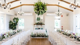 Beautifully decorated wedding venue with floral centerpieces and elegant seating, representing modern planning enhanced by AI wedding tools.