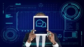 Person holding a tablet displaying a chat icon against a digital interface background, representing AI-powered communication in online chat systems.