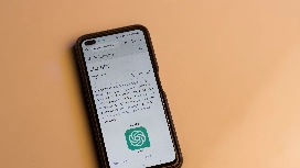 Smartphone displaying ChatGPT information, representing task automation, AI workflows, and productivity tools