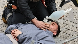 Emergency responder providing basic life support with a bag valve mask during an emergency response training scenario
