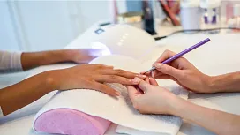 A beauty therapist performing a basic manicure on a client’s hand, representing beginner Level 1 beauty therapy and salon management training.