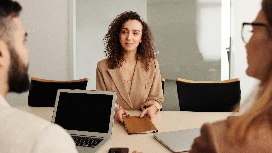 Professional job candidate answering competency-based interview questions, demonstrating communication skills and interview readiness