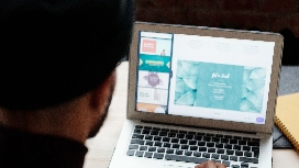 Freelancer working on a laptop to build online services and manage a home-based freelance business remotely