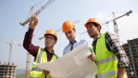 Construction professionals collaborating on plans, illustrating teamwork activities and high-performing team development skills