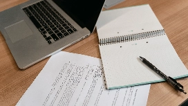 Business administration fundamentals course with laptop, notebook, and documents illustrating administration in a business