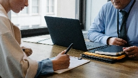 Professionals collaborating in a meeting, demonstrating communication and business communication skills for workplace success