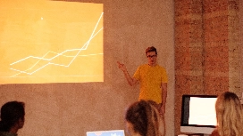 Business analytics instructor presenting data trends and performance charts during a business data analytics training session