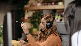 Call centre agent communicating with clients through a headset, demonstrating professional communication skills