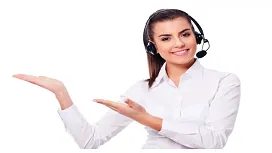 A smiling call centre representative wearing a headset gestures with open hands, symbolizing communication and support skills in call centre training.