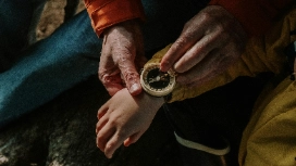 Adult gently holding a child’s foot, symbolising care and safeguarding – learn child protection in this short course