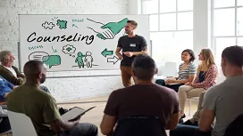 Group counselling session with a facilitator guiding participants, representing advanced communication and support skills taught in Level 5 counselling courses.