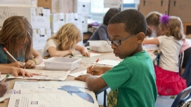 Children drawing in a supervised classroom, showing a safe, supportive learning space – child safe environment course