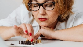 Professional analysing information and evaluating options, demonstrating critical thinking as a skill for effective decision making